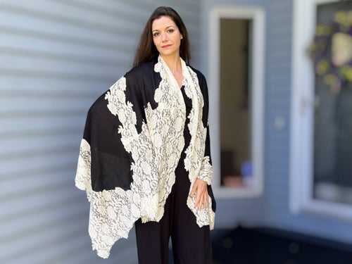 Black and white wool and silk lace scarf by Amoura, showcasing elegant woven texture and delicate lace detailing.